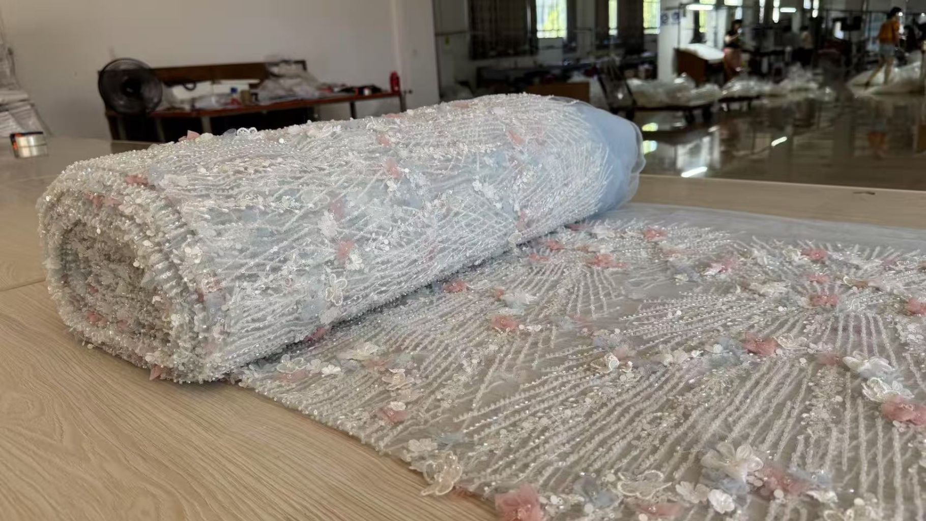 A roll of delicate Chantilly lace fabric for wholesale